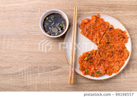Kimchi pancake (Kimchi jeon or kimchi buchimgae) on plate eating with soy dipping sauce, Korean food, Table top view 99198557