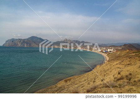 View of seaside resort city Koktebel , mountain Kara Dag from hill in spring. Crimea 99199996