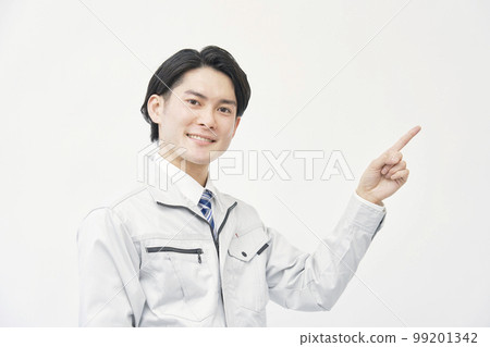 A man in work clothes pointing to the right White background A man in work clothes pointing to the right White background 99201342
