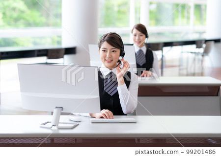 Young woman working in a call center 99201486