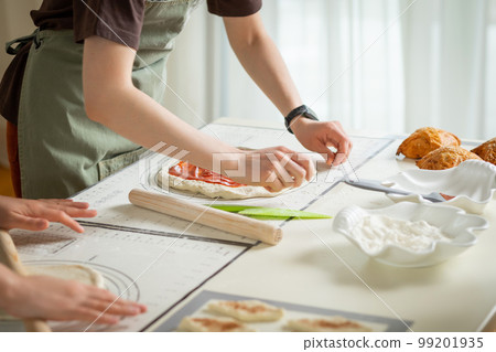 Cooking desserts in a large kitchen by two chefs on silicone kitchen mats 99201935