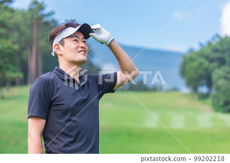 A golfer man playing golf on a golf course (smile) A golfer man playing golf on a golf course (smile) 99202218