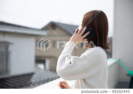 Woman talking on the veranda Woman talking on the veranda 99202443