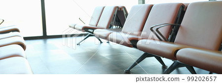 Location in airport terminal. Leather light brown armchairs at station station 99202657