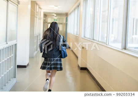 High school girl running in the school corridor 99203334