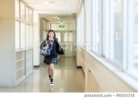 High school girl running in the school corridor 99203338
