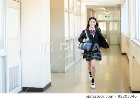 High school girl running in the school corridor High school girl running in the school corridor 99203340