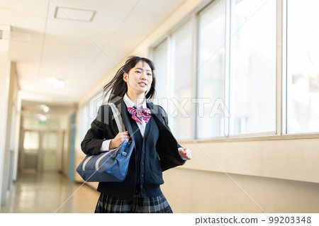 High school girl running in the school corridor High school girl running in the school corridor 99203348
