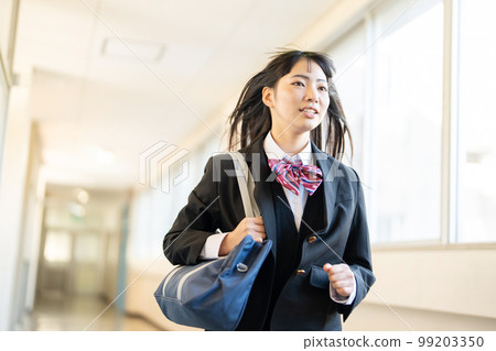 High school girl running in the school corridor 99203350