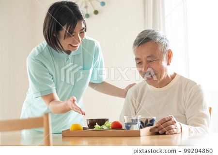 Caregiver serving meals 99204860