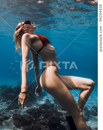Underwater portrait of sexy woman in bikini in blue ocean. Freediving and beautiful lady 99204926