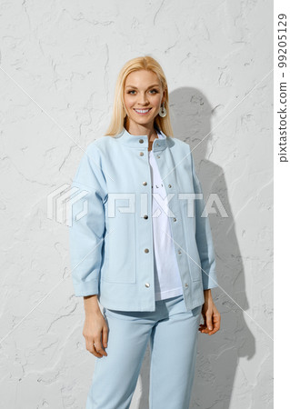 Joyful woman in blue jeans, jacket and white shirt 99205129