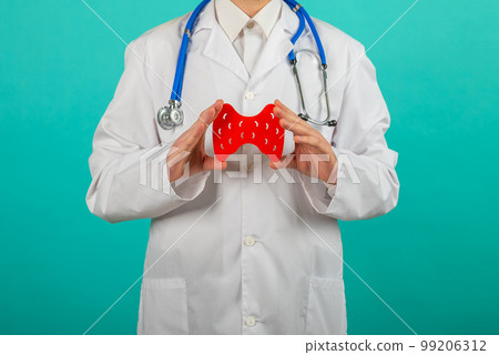 Male doctor holding mockup thyroid gland. Help and care concept 99206312