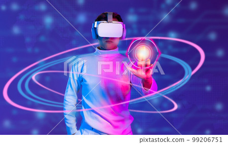 Metaverse technology concept. Man in white t shirt wearing VR headset scanning fingerprint to connect world virtual data and entertainment on blurred background.. 99206751