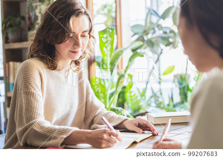 Woman writing on a notebook 99207683