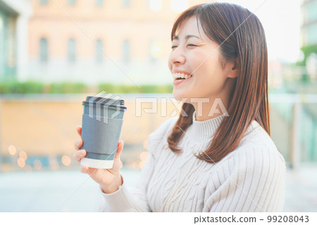 A woman who drinks coffee and takes a break A woman who drinks coffee and takes a break 99208043
