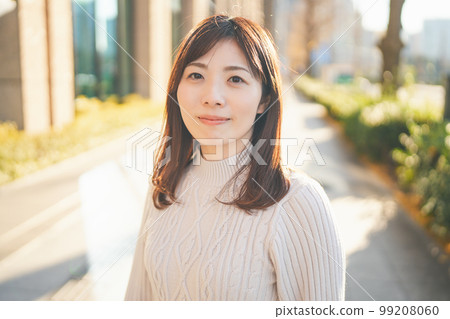 Woman smiling outdoors in winter 99208060