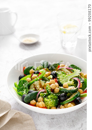 Chickpea and spinach vegan vegetable salad with broccoli, sweet pepper, olives and grilled zucchini. Mediterranean diet, healthy food 99208170