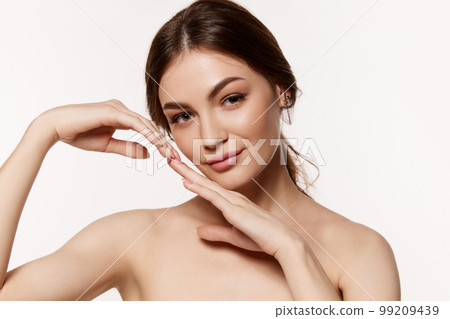 Portrait of young beautiful brunette woman with perfect smooth skin isolated over white background. Clear well-kept skin 99209439