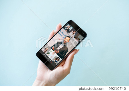 Mobile conference. Business webinar. Video meeting. Professional colleagues group working on smartphone screen on blue empty space background. 99210740