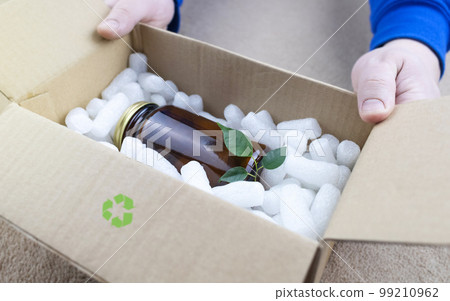 Eco package of parcels and biodegradable filler. Box is filled with a filler that does not harm the environment. Delivery of goods, parcels, delivery service, nature protection. Recycling Eco package of parcels and biodegradable filler. Box is filled with a filler that does not harm the environment. Delivery of goods, parcels, delivery service, nature protection. Recycling 99210962