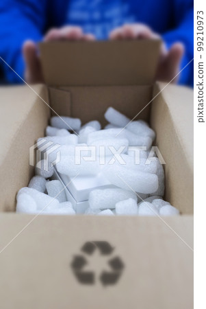 Eco package of parcels and biodegradable filler. Box is filled with a filler that does not harm the environment. Delivery of goods, parcels, delivery service, nature protection.  Recycling 99210973