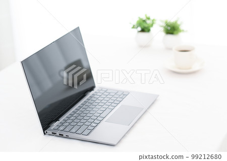 White table with laptop and coffee cup White table with laptop and coffee cup 99212680
