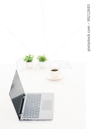 White table with laptop and coffee cup White table with laptop and coffee cup 99212683
