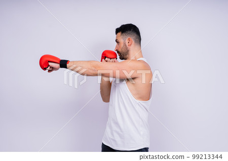 Young caucasian handsome man isolated on white background with boxing gloves Young caucasian handsome man isolated on white background with boxing gloves 99213344