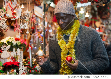 Man looking for New Year decorations 99214469