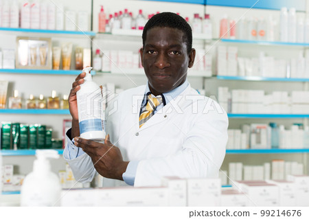 African American pharmacist offering medication 99214676
