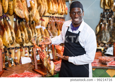 Owner of butcher shop selling jamon Owner of butcher shop selling jamon 99214716