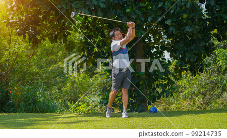 Golfer playing golf in the evening golf course, on sun set evening time Golfer playing golf in the evening golf course, on sun set evening time 99214735