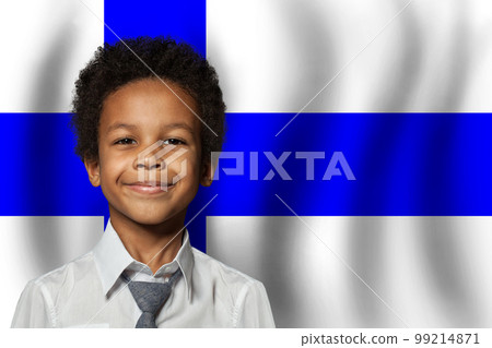 Finnish kid boy on flag of Finland background. Education and childhood concept 99214871