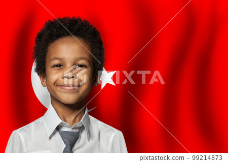 Turkish kid boy on flag of Turkey background. Education and childhood concept 99214873