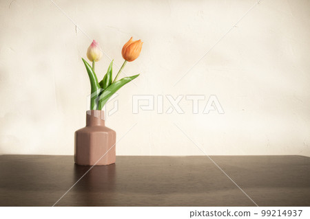 Two types of tulips on a brown flower base Two types of tulips on a brown flower base 99214937