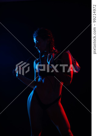 Sporty female with great abdominal muscles in black sportswear. A great sport body close up. Sporty female with great abdominal muscles in black sportswear. A great sport body close up. 99214972