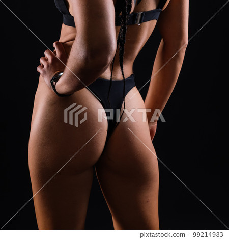 Sporty female with great abdominal muscles in black sportswear. A great sport body close up. Sporty female with great abdominal muscles in black sportswear. A great sport body close up. 99214983