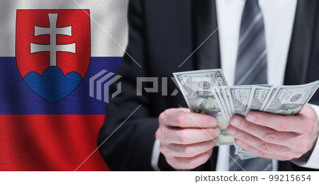 Hands holding dollar money on flag of Slovakia 99215654
