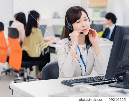 A woman at the customer center who is tired from answering the phone A woman at the customer center who is tired from answering the phone 99216215
