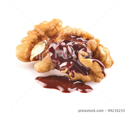 Walnuts kernel with chocolate drop in closeup on white background 99216233