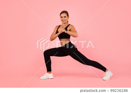 Portrait Of Young Athletic Woman Training Over Pink Background In Studio Portrait Of Young Athletic Woman Training Over Pink Background In Studio 99216286