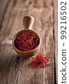 Saffron threads on wooden background 99216502