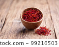 Saffron threads on wooden background 99216503