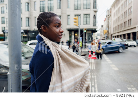 Attractive young african woman walking in the city 99217462