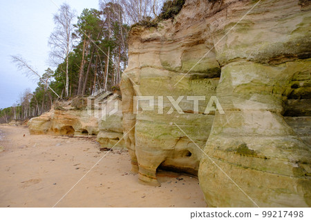 Beautiful in any weather, colorful sandstone cliffs. Beautiful coast of the Baltic Sea with caves. Veczemju klints, Veczemju cliffs in the Baltic Sea, Latvia 99217498
