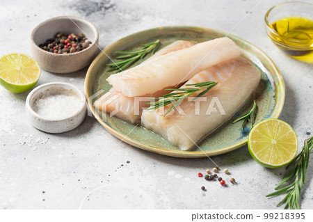 Ceramic plate with fresh raw cod fish, aromatic herbs Ceramic plate with fresh raw cod fish, aromatic herbs 99218395