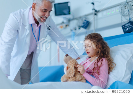 Friendly doctor taking care and playing with little girl. 99221060
