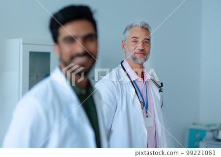 Portrait of mature doctor at hospital room. 99221061