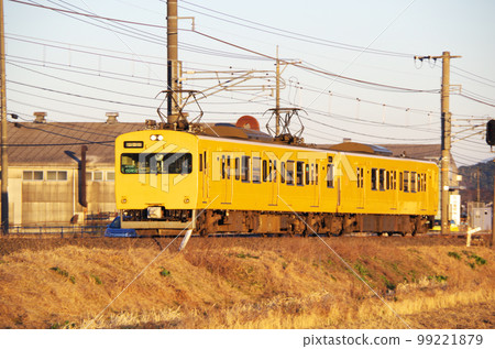 A yellow local train running along the Nakaumi line in the evening A yellow local train running along the Nakaumi line in the evening 99221879